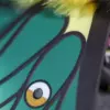 A close-up of hand-sculpted green wing with eye spot detail on Spanish Moon Moth doll