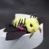 A side view of Spanish Moon Moth doll posed on a curved white platform