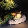 Spanish Moon Moth plush doll glowing softly under tree light — realistic moth toy with lifelike wings