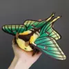 Spanish Moon Moth plush doll in hand — detailed view of wings and scale of the handmade insect toy