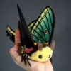 Spanish Moon moth plush doll with large green wings and yellow faux fur, held in hand