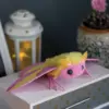 Rosy Maple Moth plush doll sitting on a wooden box with decorative lantern and cactus