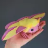 Side view of Rosy Maple Moth plush doll with vibrant pink and yellow wings held in hand – artisanal collectible moth stuffed animal